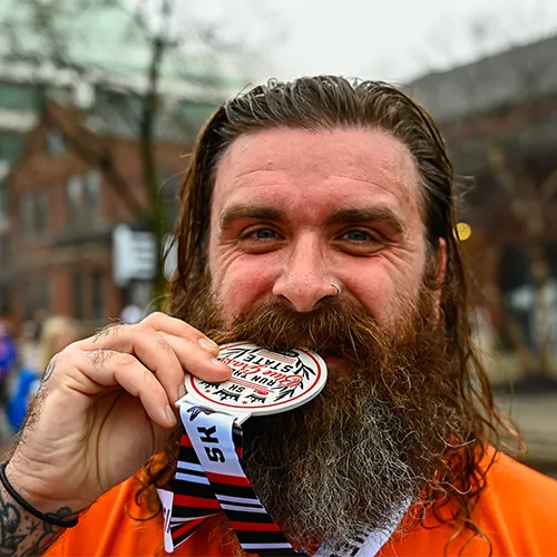 man biting medal man biting medal
