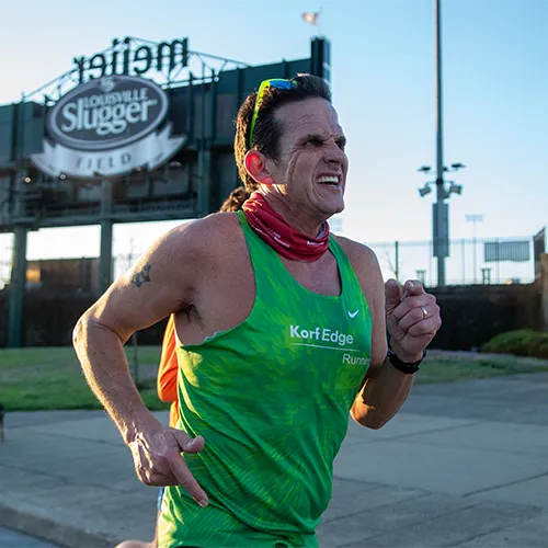 man in green shirt running man in green shirt running